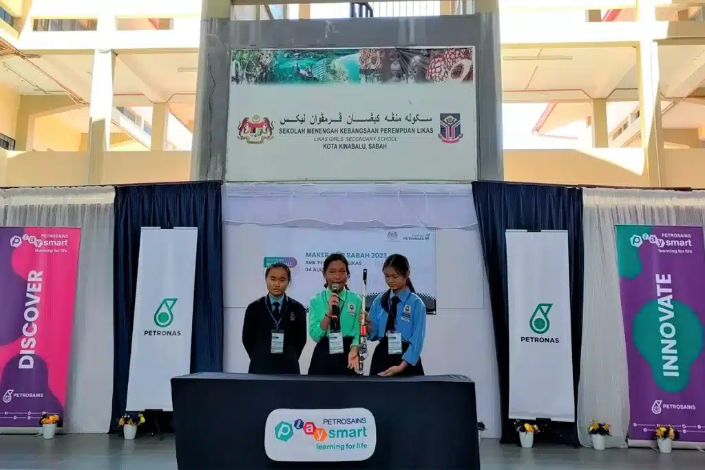 Students from SMK St. Peter Telipok, Sabah who are also participants of the Yayasan PETRONAS Coding4All programme presenting their innovation, a walking stick equipped with sensor to assist the blind.